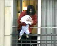 Michael dangles his baby